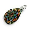 Angled view of Teardrop Mandala Glass Pendant with stained-glass-inspired floral pattern and clear loop.