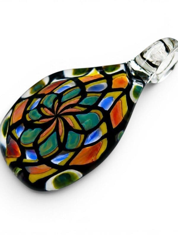 Angled view of Teardrop Mandala Glass Pendant with stained-glass-inspired floral pattern and clear loop.